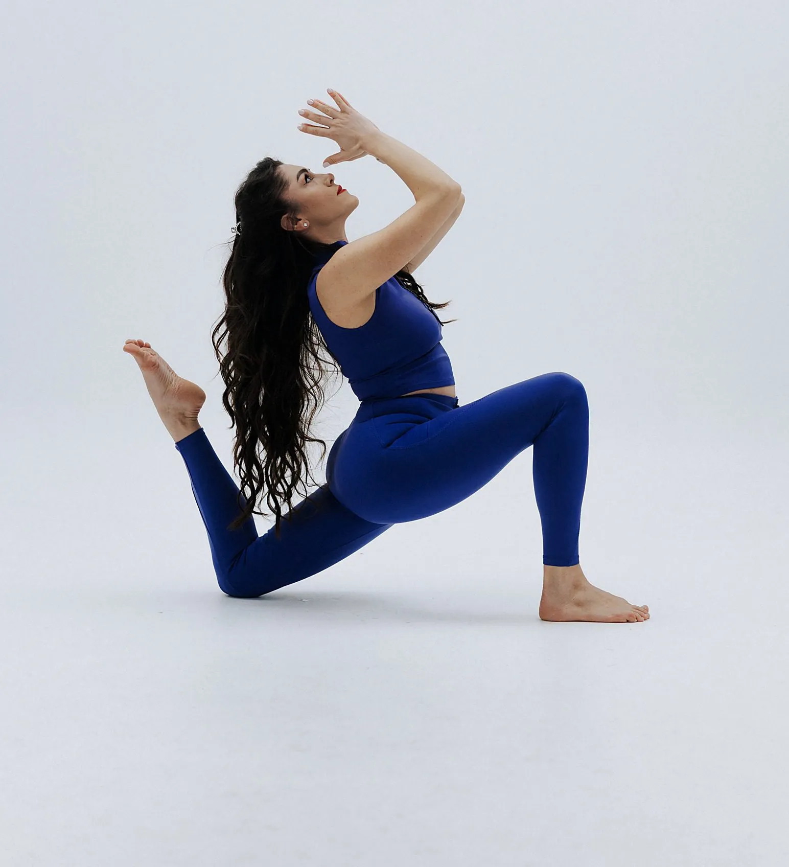 Yoga class, deep lunge with hands behind the head